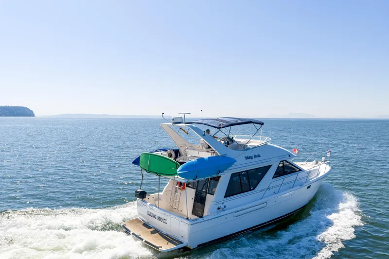  Yacht Photos Pics 1997 Bayliner 3988 yacht cruising on open water under clear blue skies.