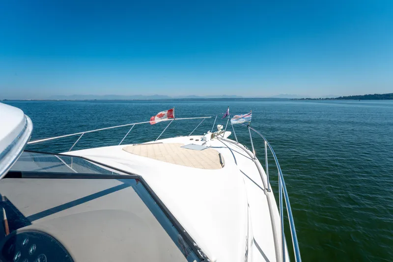  Yacht Photos Pics Bayliner 3988 yacht cruising on open water under clear blue sky, 1997 model.