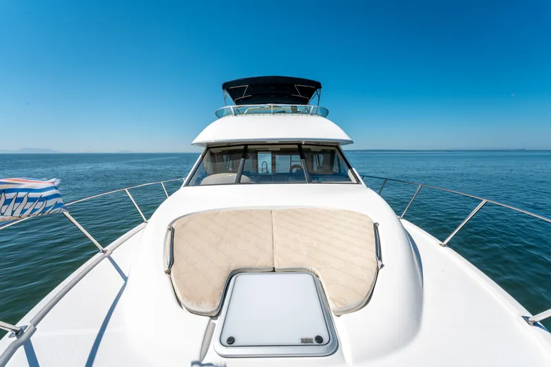  Yacht Photos Pics 1997 Bayliner 3988 yacht cruising on open water under clear blue skies.