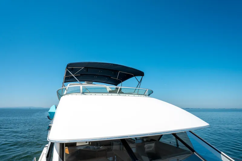  Yacht Photos Pics 1997 Bayliner 3988 yacht on calm sea under clear blue sky.