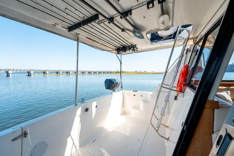  Yacht Photos Pics 1997 Bayliner 3988 boat interior with open deck, overlooking calm water and distant bridge.