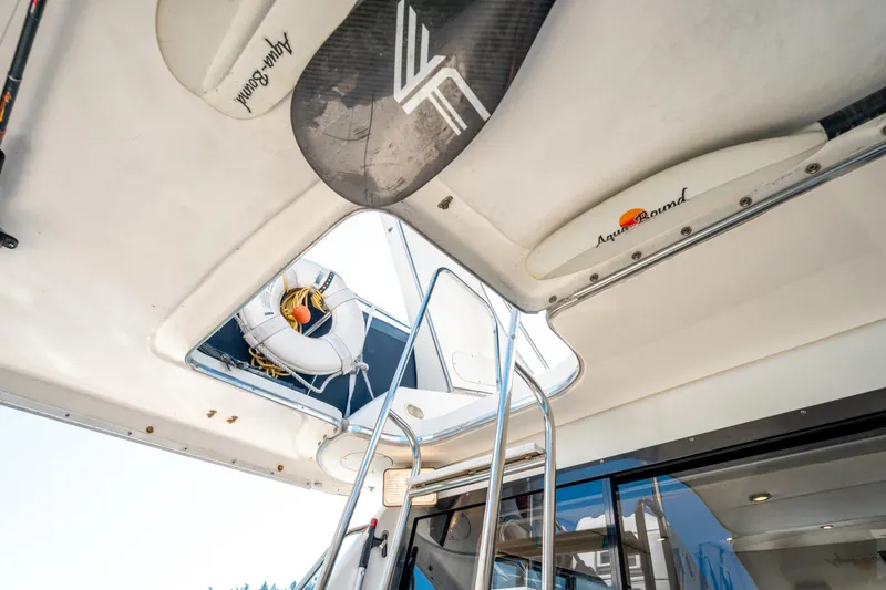  Yacht Photos Pics 1997 Bayliner 3988 yacht interior with ladder, life preserver, and surfboard storage.