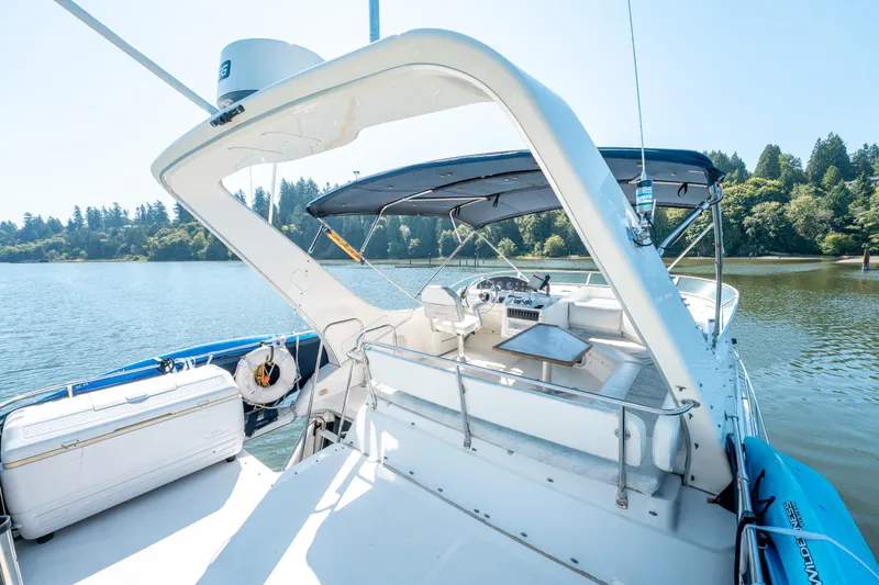  Yacht Photos Pics 1997 Bayliner 3988 yacht with spacious deck, moored on a serene lake.