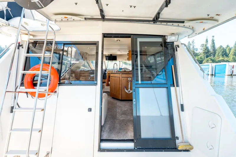  Yacht Photos Pics 1997 Bayliner 3988 yacht interior view with ladder, life preserver, and open sliding door.