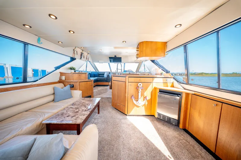  Yacht Photos Pics Luxurious interior of a 1997 Bayliner 3988 yacht with panoramic windows and elegant furnishings.