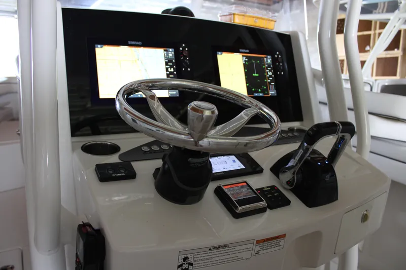  Yacht Photos Pics 2018 Jupiter 30 HFS boat dashboard with steering wheel and navigation screens.