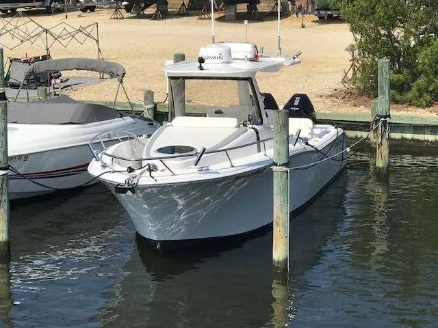  Yacht Photos Pics 2020 Belzona 27 Walkaround boat docked in marina, featuring sleek design and modern equipment.