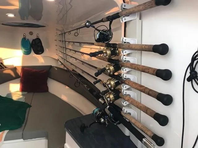  Yacht Photos Pics Interior of 2020 Belzona 27 Walkaround with fishing rods and cozy seating area.