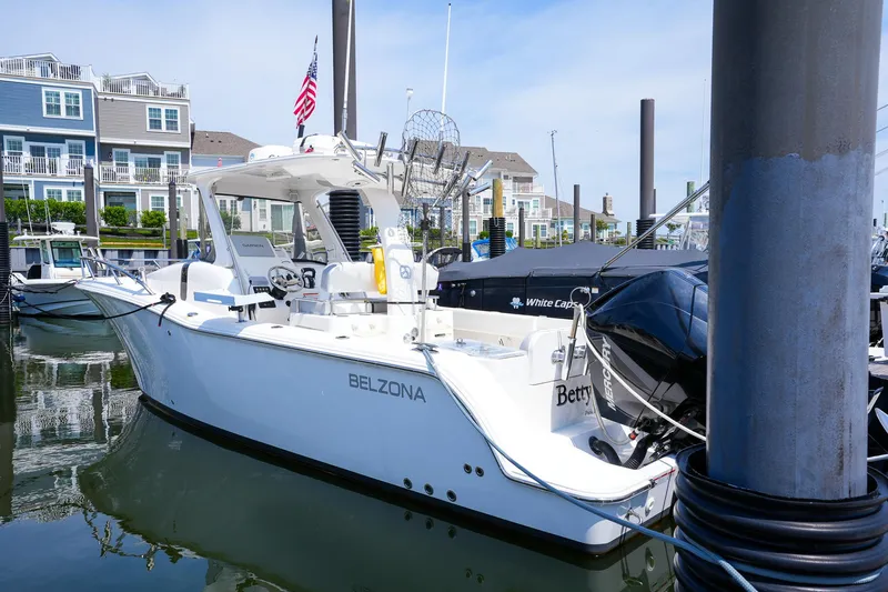  Yacht Photos Pics 2020 Belzona 27 Walkaround boat docked in marina with residential backdrop.