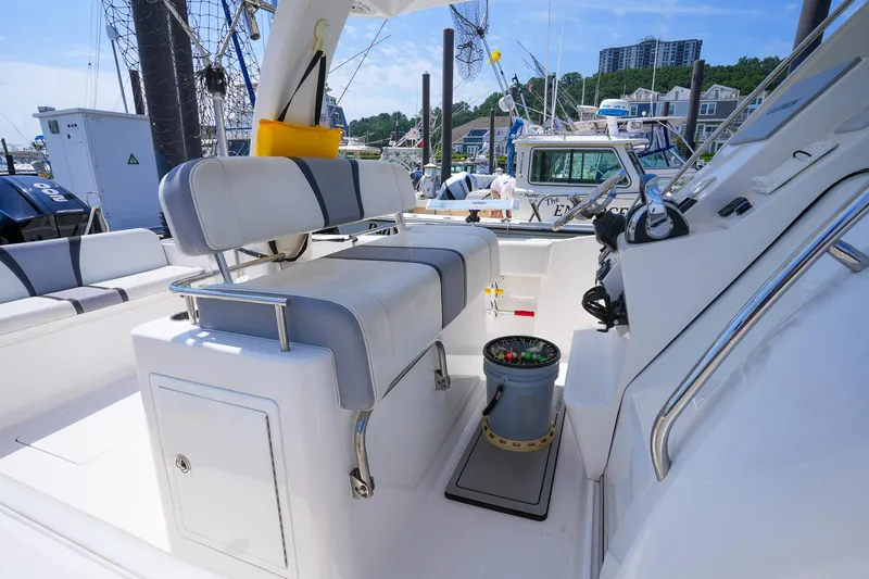  Yacht Photos Pics 2020 Belzona 27 Walkaround boat interior with seating and fishing gear at a marina.