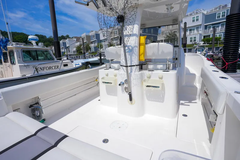  Yacht Photos Pics 2020 Belzona 27 Walkaround boat interior at marina, featuring seating and fishing equipment.