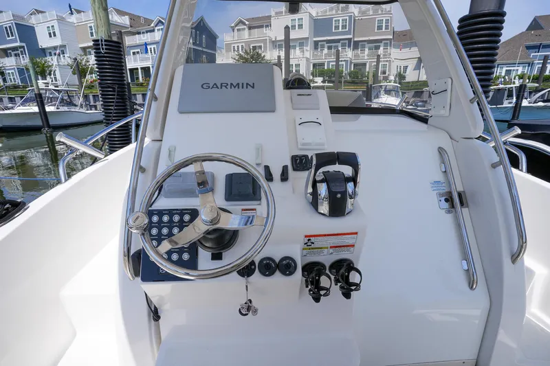  Yacht Photos Pics 2020 Belzona 27 Walkaround boat helm with Garmin navigation system, docked near waterfront homes.