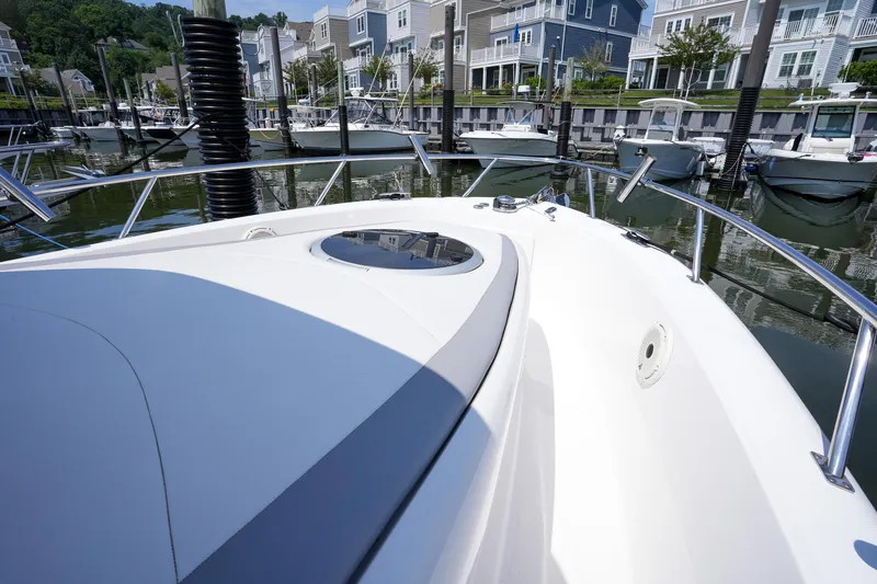  Yacht Photos Pics 2020 Belzona 27 Walkaround boat docked in a marina with waterfront homes.