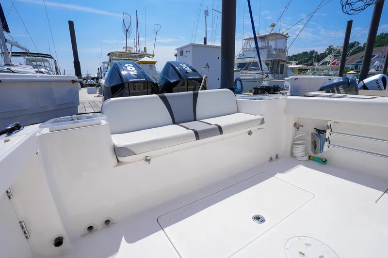  Yacht Photos Pics 2020 Belzona 27 Walkaround boat interior with seating and twin outboard engines at a marina.