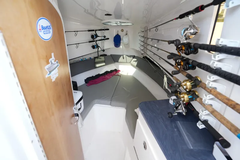  Yacht Photos Pics 2020 Belzona 27 Walkaround cabin with fishing rods and seating area.
