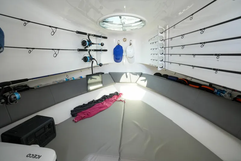  Yacht Photos Pics 2020 Belzona 27 Walkaround cabin with fishing rods and seating.