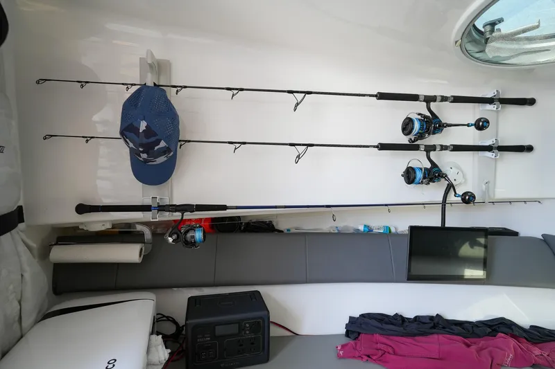  Yacht Photos Pics Interior of 2020 Belzona 27 Walkaround with fishing rods and gear neatly organized.