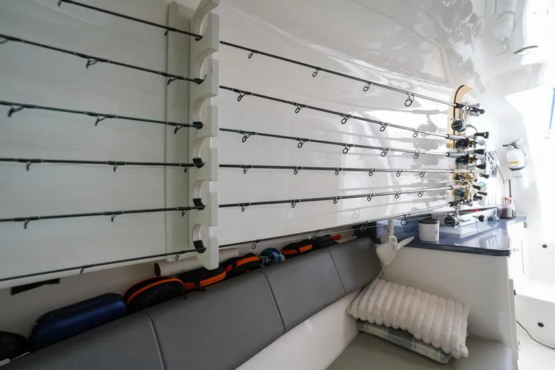  Yacht Photos Pics Interior of 2020 Belzona 27 Walkaround boat with fishing rods and seating area.