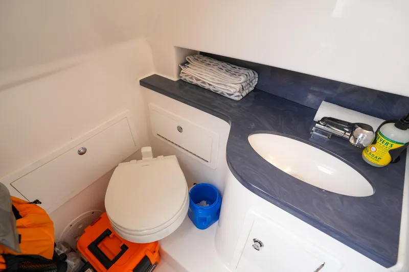  Yacht Photos Pics 2020 Belzona 27 Walkaround boat bathroom with sink, toilet, and storage.
