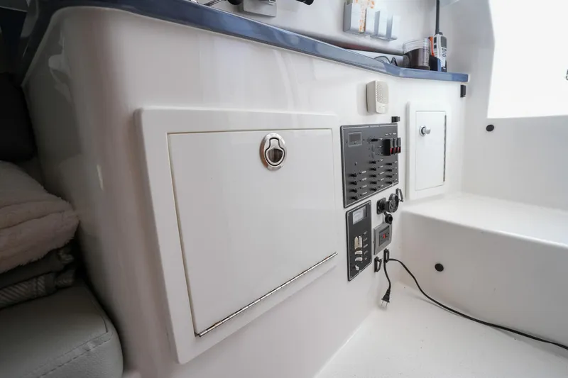  Yacht Photos Pics 2020 Belzona 27 Walkaround interior with control panel and storage compartments.