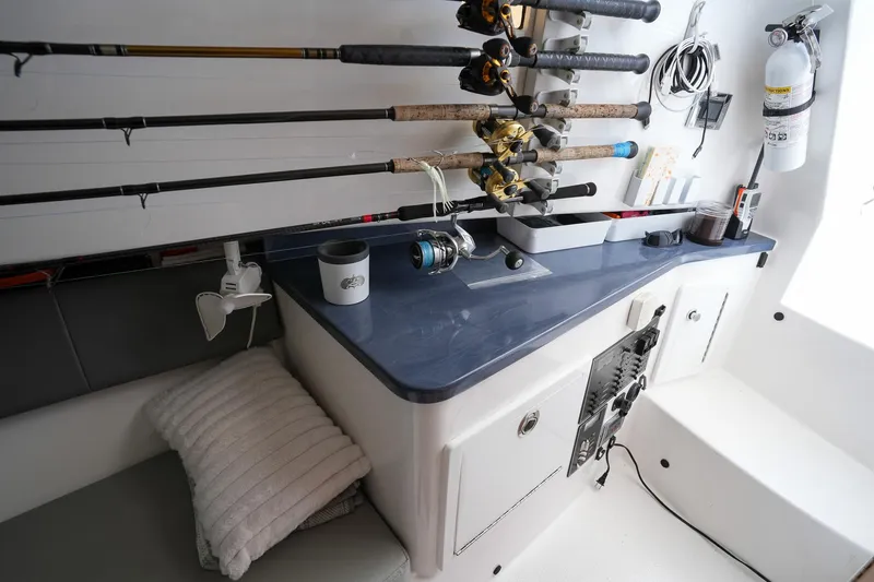  Yacht Photos Pics Interior of a 2020 Belzona 27 Walkaround boat with fishing rods and equipment.