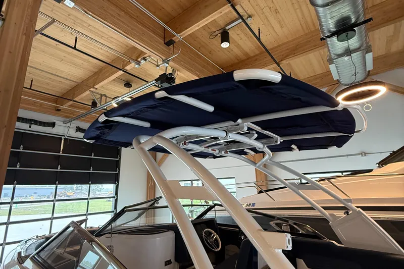  Yacht Photos Pics 2020 Cobalt A29 boat with sleek design in a modern showroom.