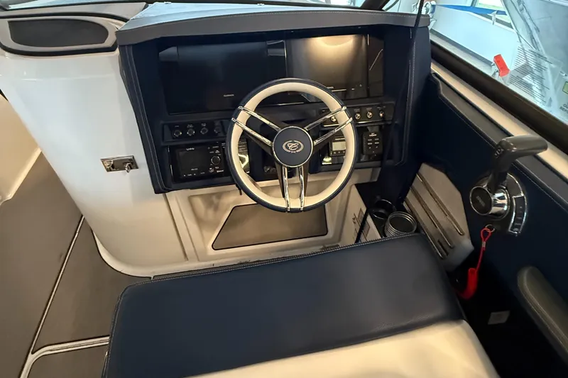  Yacht Photos Pics Interior view of 2020 Cobalt A29 boat cockpit with steering wheel and control panel.