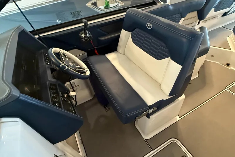  Yacht Photos Pics Interior of 2020 Cobalt A29 boat with blue and white seating and steering wheel.