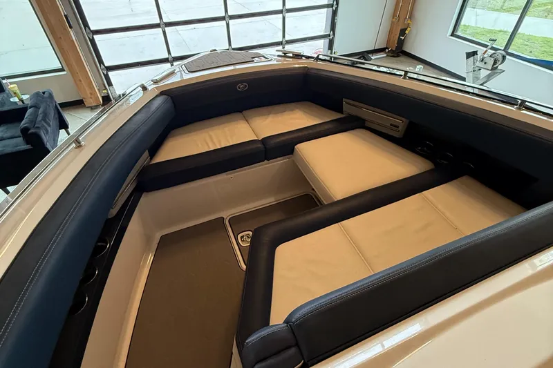  Yacht Photos Pics 2020 Cobalt A29 boat interior with luxurious seating in a modern garage setting.