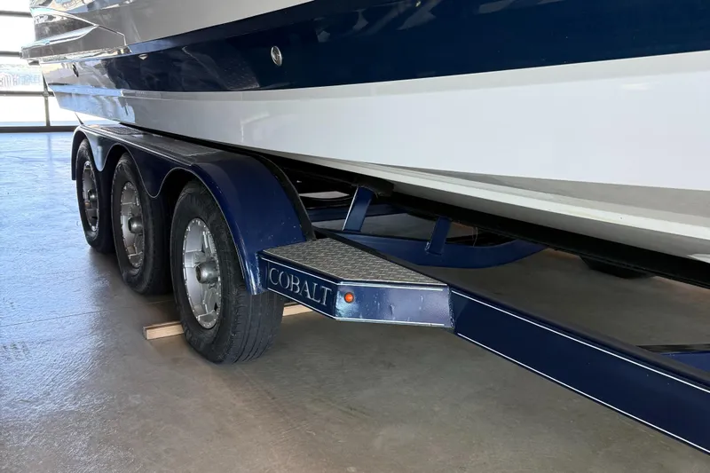  Yacht Photos Pics 2020 Cobalt A29 boat on a triple-axle trailer in a garage.