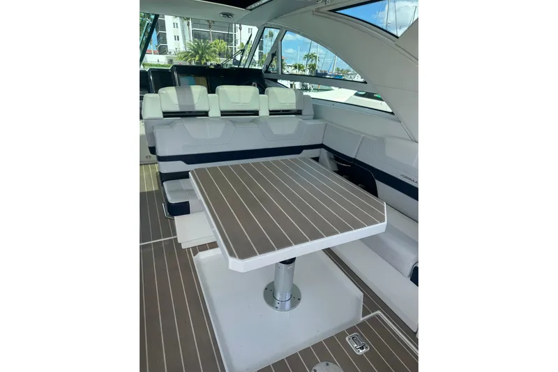  Yacht Photos Pics 2023 Formula 430 All Sport Crossover interior with seating and table, docked at marina.