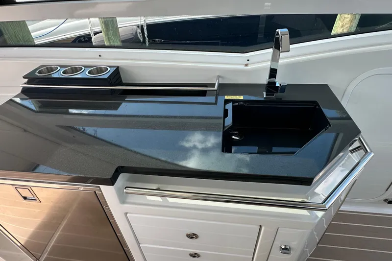  Yacht Photos Pics 2023 Formula 430 All Sport Crossover yacht kitchen with sleek black countertop and modern sink.