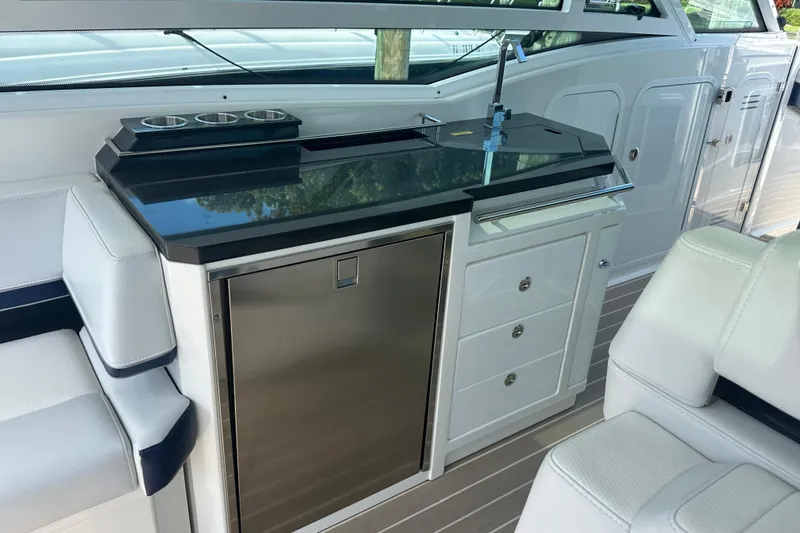  Yacht Photos Pics 2023 Formula 430 All Sport Crossover boat interior with kitchenette and seating area.
