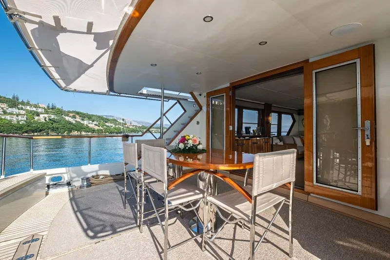 Stalca Yacht Photos Pics Luxurious Visch 001 yacht deck with dining area, scenic waterfront view, built in 1971.