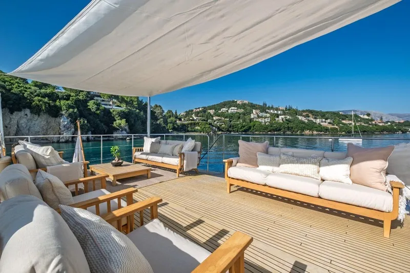 Stalca Yacht Photos Pics Luxurious yacht deck with comfortable seating, overlooking serene coastal landscape. Visch 001, 1971.