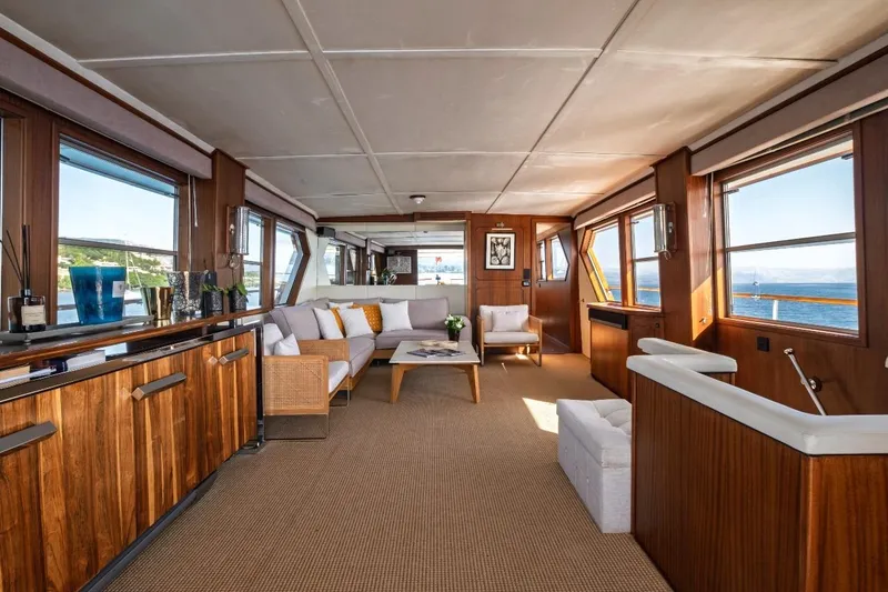 Stalca Yacht Photos Pics Luxurious interior of 1971 Visch 001 yacht with elegant wood paneling and panoramic windows.