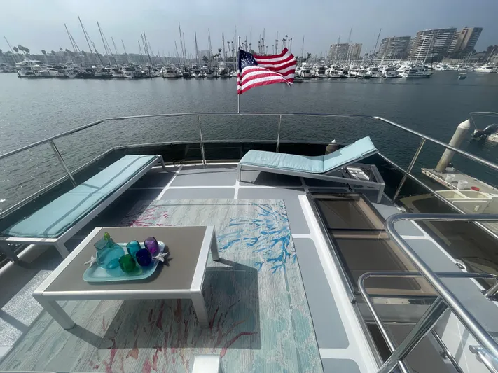 Sand Castle Yacht Photos Pics Luxurious 1996 Johnson 70 Euro yacht deck with seating, table, and American flag in marina.