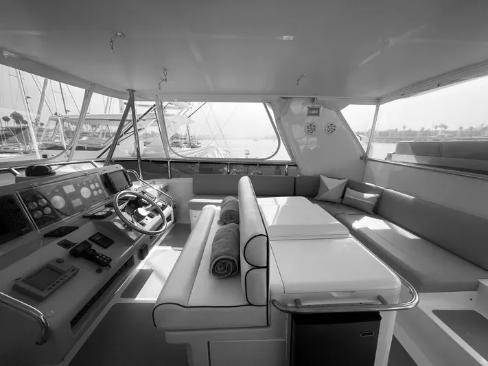 Sand Castle Yacht Photos Pics Interior of 1996 Johnson 70 Euro yacht with steering wheel and seating area.