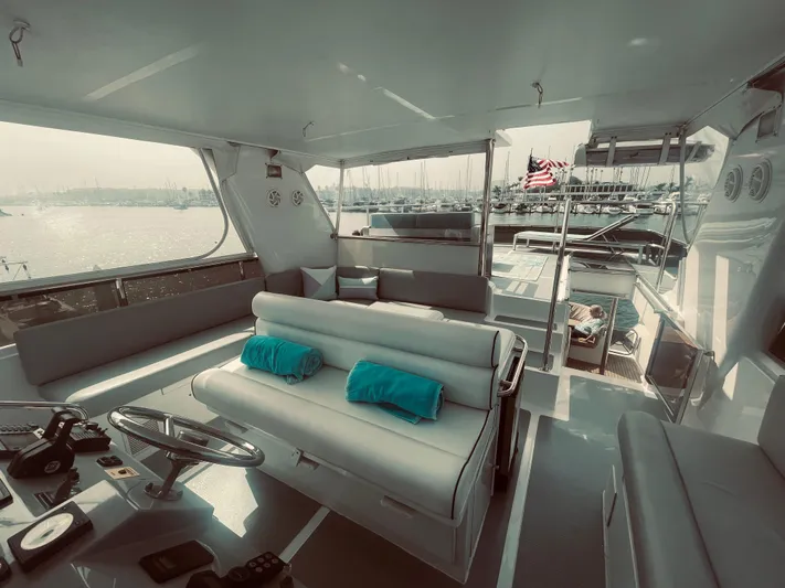 Sand Castle Yacht Photos Pics Interior of a 1996 Johnson 70 Euro yacht with plush seating and scenic marina view.