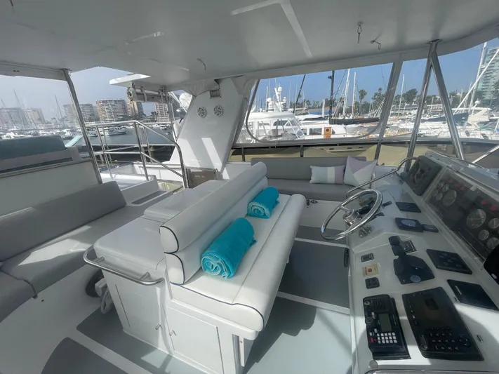 Sand Castle Yacht Photos Pics Luxurious 1996 Johnson 70 Euro yacht interior with helm, seating, and marina view.