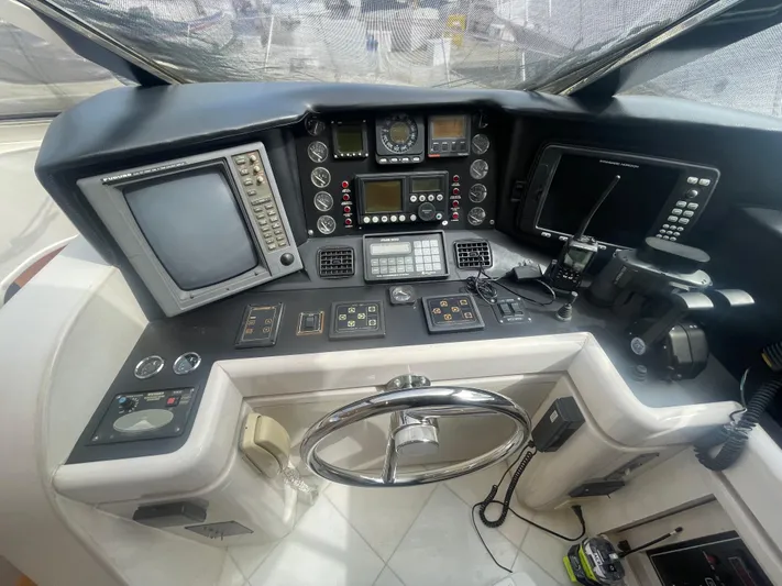 Sand Castle Yacht Photos Pics Cockpit of a 1996 Johnson 70 Euro yacht with navigation instruments and steering wheel.