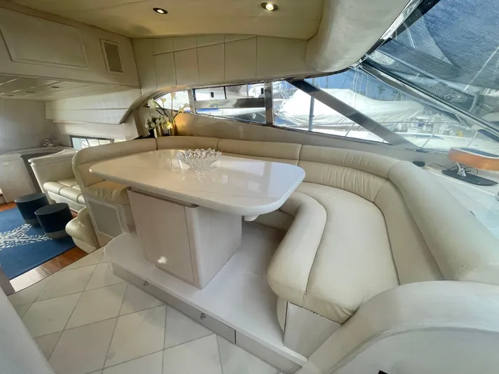 Sand Castle Yacht Photos Pics Luxurious interior of a 1996 Johnson 70 Euro yacht with elegant white seating and table.