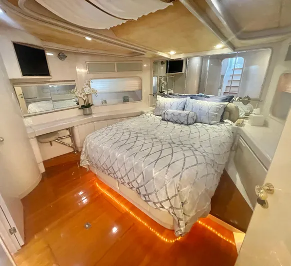 Sand Castle Yacht Photos Pics Luxurious bedroom interior of a 1996 Johnson 70 Euro yacht with elegant bedding and ambient lighting.