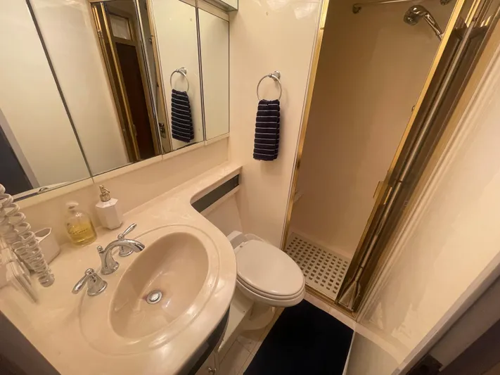 Sand Castle Yacht Photos Pics Compact bathroom with sink, toilet, and shower in a 1996 Johnson 70 Euro yacht.