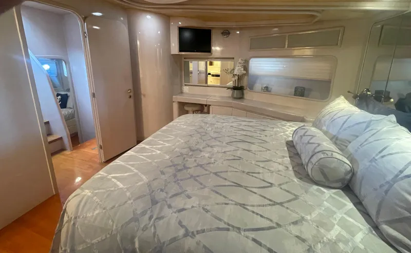 Sand Castle Yacht Photos Pics Luxurious bedroom interior of a 1996 Johnson 70 Euro yacht with elegant bedding and modern decor.