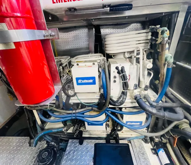 Sand Castle Yacht Photos Pics Engine room of a 1996 Johnson 70 Euro yacht with mechanical components and fire extinguisher.