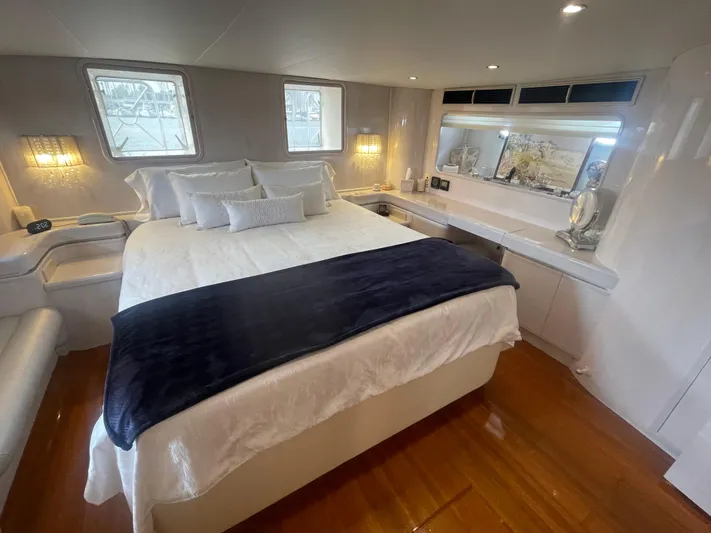Sand Castle Yacht Photos Pics Luxurious bedroom interior of a 1996 Johnson 70 Euro yacht with elegant decor and lighting.