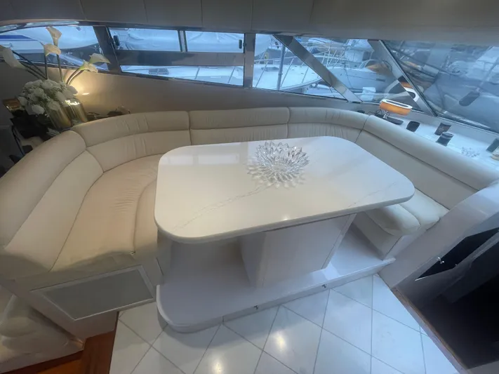 Sand Castle Yacht Photos Pics Luxurious interior of a 1996 Johnson 70 Euro yacht with elegant seating and table.