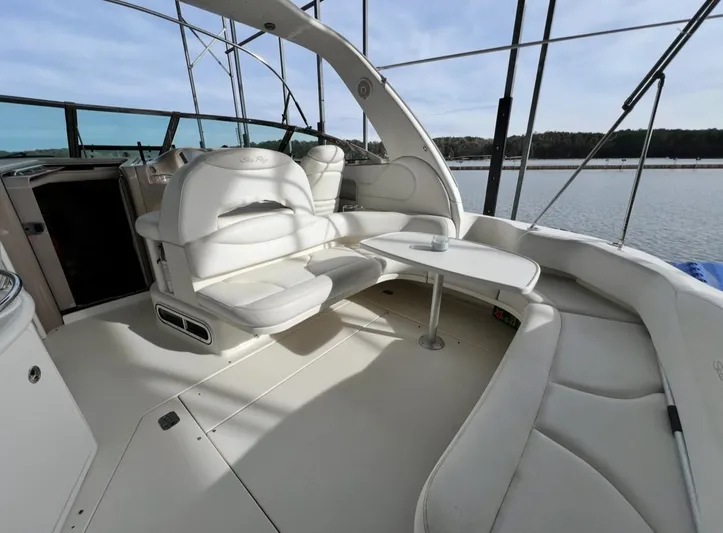  Yacht Photos Pics 2001 Sea Ray 380 Sundancer yacht interior with white seating and table, overlooking water.