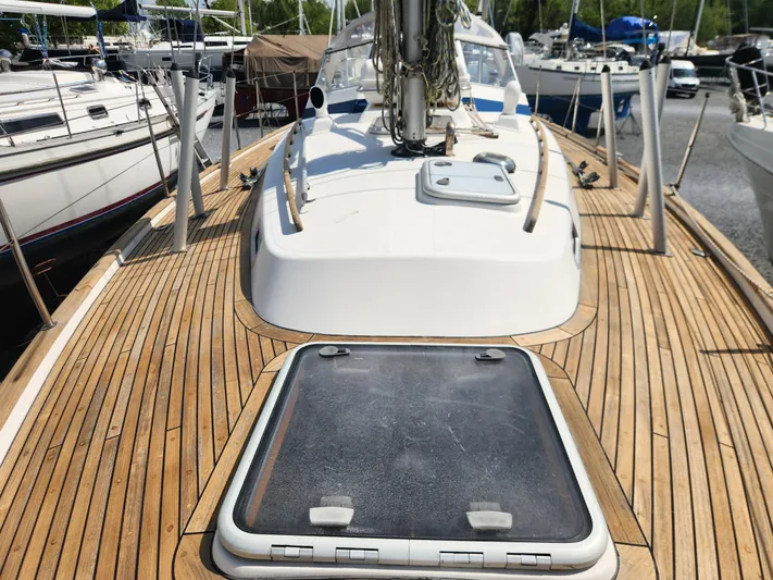 Vivace 1 Yacht Photos Pics Hallberg-Rassy 36 MKII 2002 sailboat with teak deck and hatch, docked in a marina.